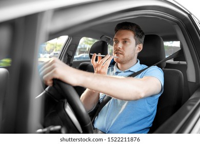 Transport, Vehicle And People Concept - Man Or Driver Driving Car And Recording Message Using Voice Command Recorder On Smartphone