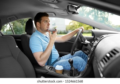 Transport, Vehicle And People Concept - Man Or Driver Driving Car And Recording Message Using Voice Command Recorder On Smartphone