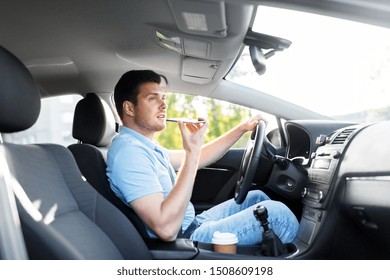 Transport, Vehicle And People Concept - Smiling Man Or Driver Driving Car And Recording Message Using Voice Command Recorder On Smartphone