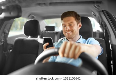 transport, vehicle and technology concept - smiling man or driver driving car and using smartphone - Powered by Shutterstock