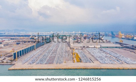 Transportation aerial view from drone top view new cars lined up in the port for import and export.Stock waiting for export
