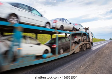 transportation of car on semi-trailer on country highway