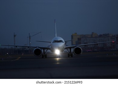 Transportation concept - Plane on taxiway, evening airport at dusk