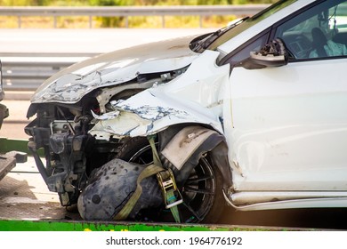 transportation of a crashed car on a sunny day - Shutterstock ID 1964776192