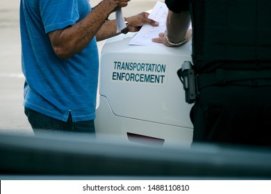 Transportation Enforcement Officer Giving Citation To Driver