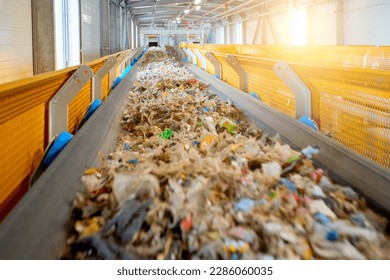  Transportation of fuel obtained from waste (RDF) on a belt to the boiler for combustion. Fuel conveyor. Processing of municipal solid waste into an energy source.   - Shutterstock ID 2286060035