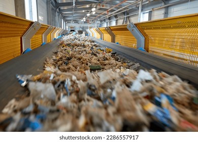 Transportation of fuel obtained from waste (RDF) on a belt to the boiler for combustion. Processing of municipal solid waste into an energy source. Utilization  waste-to-energy.  - Shutterstock ID 2286557917