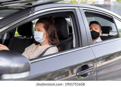 Transportation, Health And People Concept - Female Driver Driving Car With Male Passenger Wearing Face Protective Medical Mask For Protection From Virus Disease