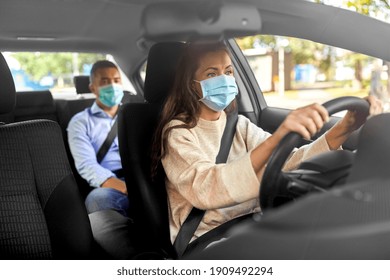 Transportation, Health And People Concept - Female Driver Driving Car With Male Passenger Wearing Face Protective Medical Mask For Protection From Virus Disease