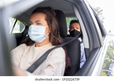 transportation, health and people concept - female driver driving car with male passenger wearing face protective medical mask for protection from virus disease