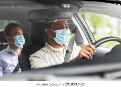 transportation, health and people concept - indian male taxi driver driving car with passenger wearing face protective medical mask for protection from virus disease