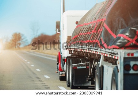 Transportation Industry Theme. Heavy Duty Cargo Transportation on Top of a Semi Truck Flatbed Trailer. American Highway.