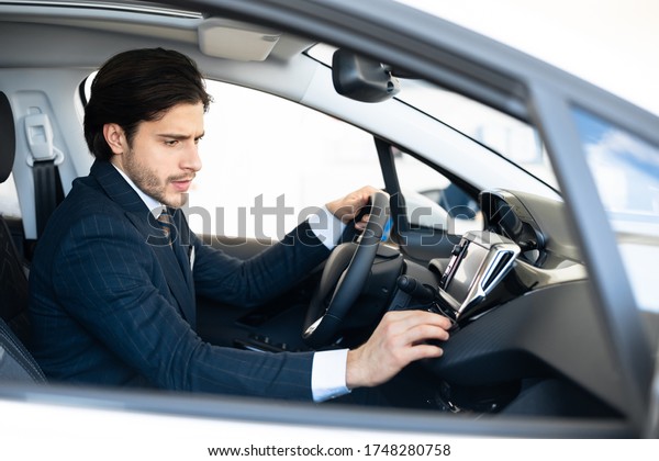 Transportation And Modern\
Technology Concept. Assistant checking navigation system on car\
dashboard screen