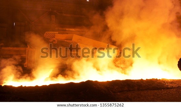 Transportation of molten hot steel in the\
chute, heavy industry concept. Stock footage. Hot molten steel in\
iron and steel\
enterprise.