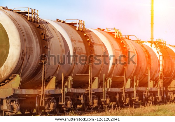 Transportation of oil tanks at sunset,\
transportation by\
rail