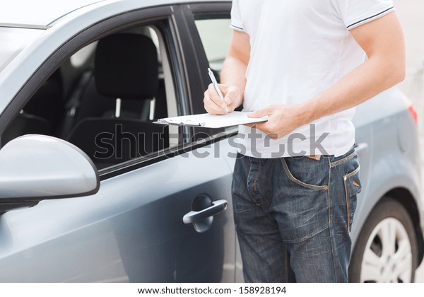 transportation and ownership concept - man with\
car documents