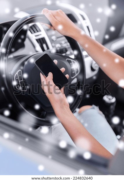 transportation, people,
technology and vehicle concept - close up of woman using smartphone
while driving
car