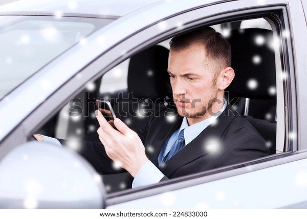 transportation, people,\
technology and vehicle concept - close up of man using smartphone\
while driving\
car