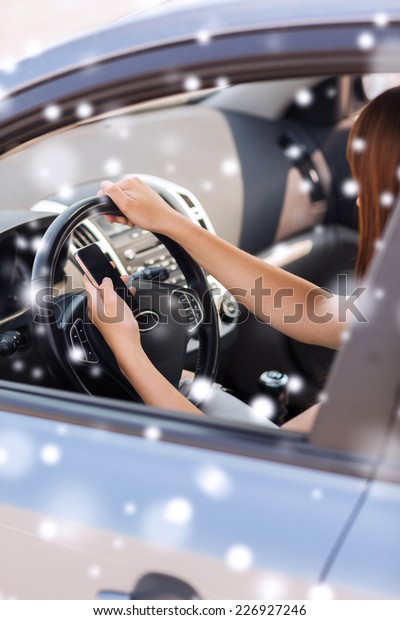 transportation, people,\
technology and vehicle concept - close up of woman using smartphone\
while driving\
car