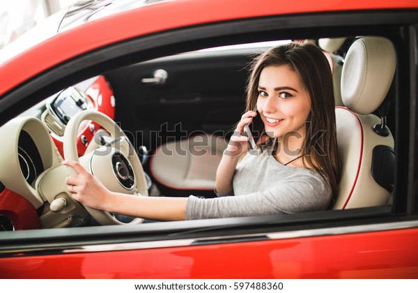transportation, people,\
technology and vehicle concept - close up of woman using smartphone\
while driving\
car