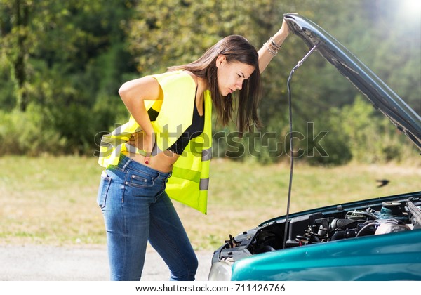 Transportation problems - Young woman with car\
problem on the\
road