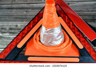 Transportation Safety And Road Repair Concept Measures For Cars Of Warning Foldaway Reflective Road Hazard Warning Triangle, Car Traffic Cone And Phosphorescent Reflective Stickers, Selective Focus