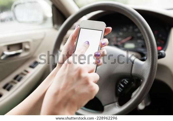 Transportation and technology concept - Woman using\
mobile phone in the\
car