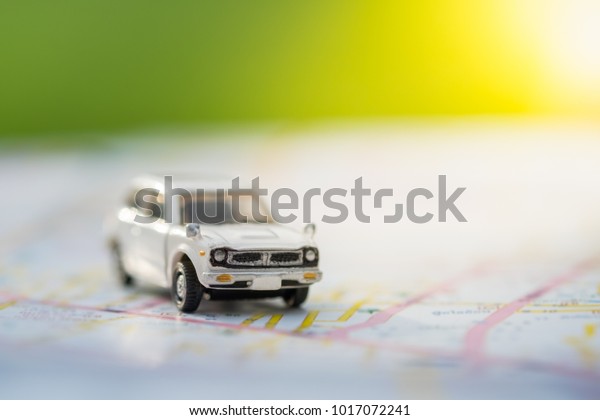 Transportation and travel concept. Mini car toy on\
world map.