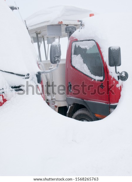 Transportation truck covered in\
snow