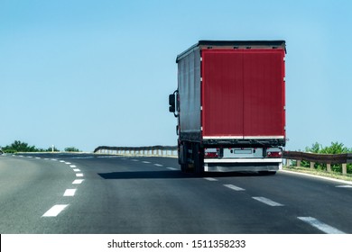 Transportation Truck on summer country highway under blue sky
