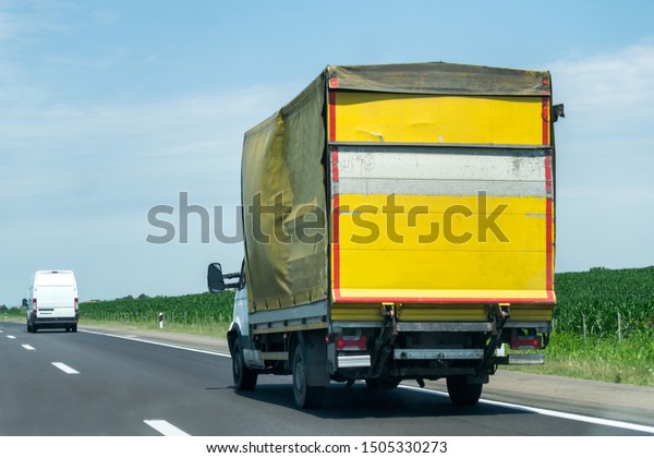 Transportation Truck on summer country highway under\
blue sky