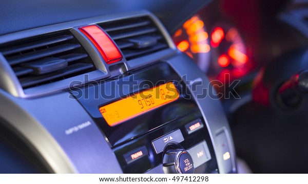 Transportation
vehicle and car auto audio concept - Car audio and radio stereo
system on car panel in evening
light