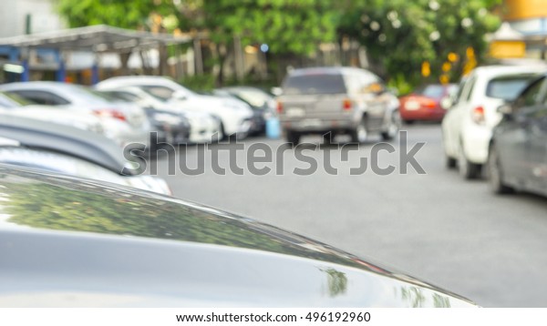 transportation vehicle and\
car parking concept - Blurred and Bokeh light of Outdoor parking\
car in evening