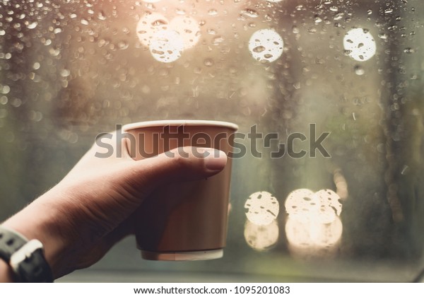 transportation and vehicle concept - driver drinking\
coffee while driving the\
car