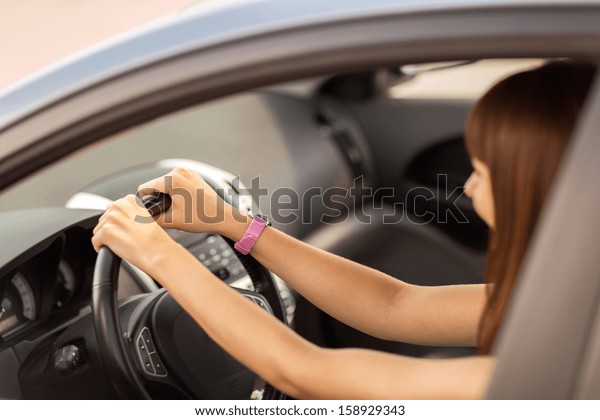 transportation and vehicle concept - happy woman\
driving a car