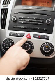 Transportation And Vehicle Concept - Man Pressing Red Triangle Car Hazard Warning Button