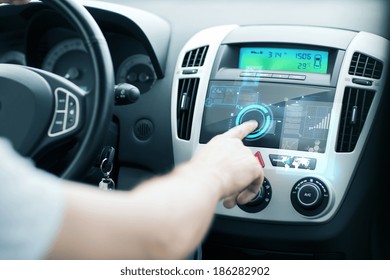 transportation and vehicle concept - man using car control panel - Shutterstock ID 186282902