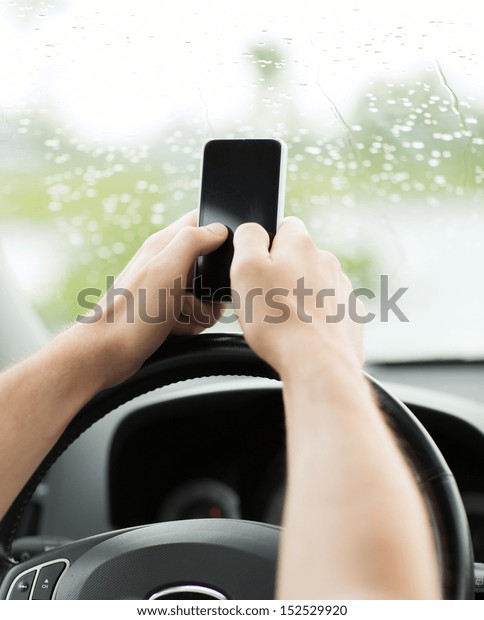 transportation and vehicle concept - man using phone
while driving the
car