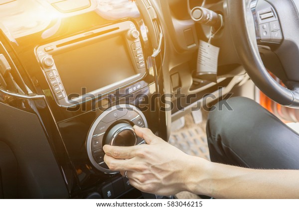 transportation and\
vehicle concept - sound stereo systems,Businessman hand driving a\
car ,Male sit inside control volume audio system Finger lie on\
wheel Empty copy space ,vintage\
color