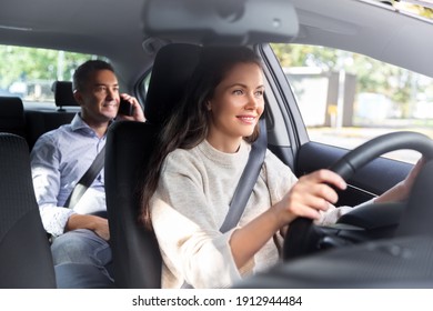 Transportation, Vehicle And People Concept - Happy Smiling Female Driver Driving Car With Male Passenger Calling On Phone