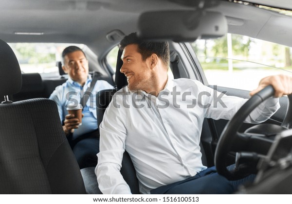 transportation, vehicle and people concept -\
male car driver talking to middle aged\
passenger