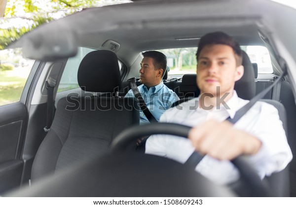 transportation, vehicle and people\
concept - middle aged male passenger on back seat and car\
driver