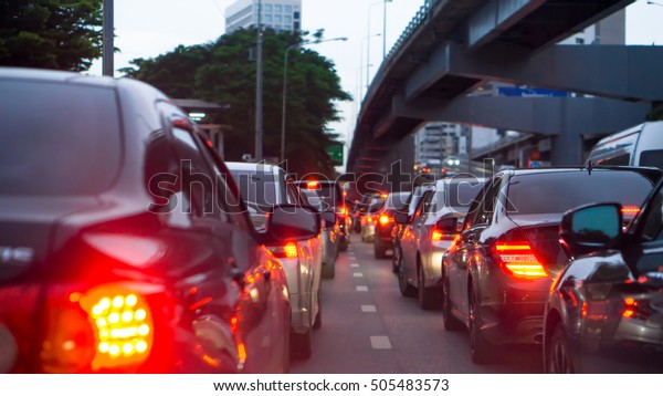 transportation vehicle and traffic concept -\
Blurred traffic jam and brake light in\
evening