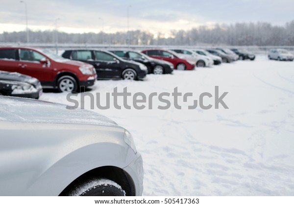 transportation, winter and vehicle concept - car\
parking with\
snow
