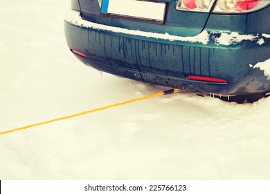 transportation, winter and vehicle concept - closeup of towing car with towing rope