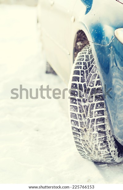 transportation, winter and vehicle concept - closeup\
of car winter\
tire