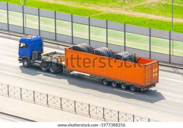 Transporting
huge dump truck tire wheels in a
container