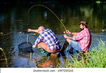 Trap For Fish. Men Sit At Riverside With Fishing Equipment. Illegal Hunting Caviar. Extracts Eggs From Sturgeon Caught River. Poaching Crime And Fishing License. Black Market Caviar. Poachers Fishing.