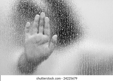 A Trapped Child With Her Hand On The Glass, Shot In Black And White