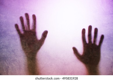 Trapped Person Concept With Back Lit Silhouette Of Hands Behind Matte Glass, Useful As Illustrative Image For Human Trafficking, Prostitution, Imprisonment, Mental Illness, Captivity, Depression.